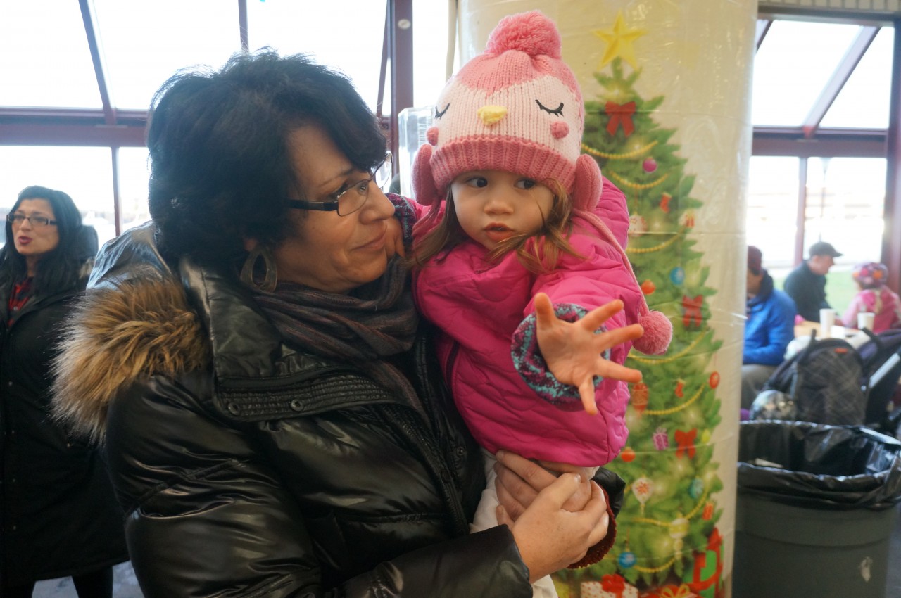 Sheila Moretti with her granddaiughter Guilia as she reaches for Santa