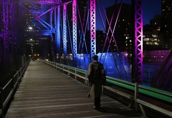 JESSICA RINALDI/GLOBE STAFF/FILE A pedestrian crosses the Old Northern Avenue Bridge one evening last May.